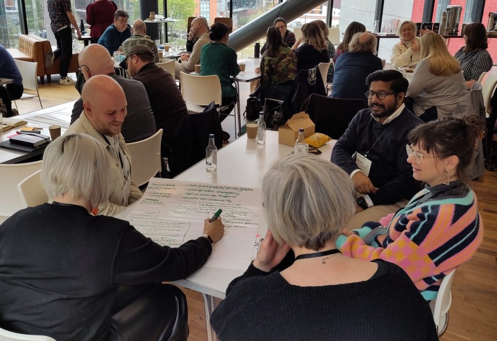 People smiling and talking in a group discussion