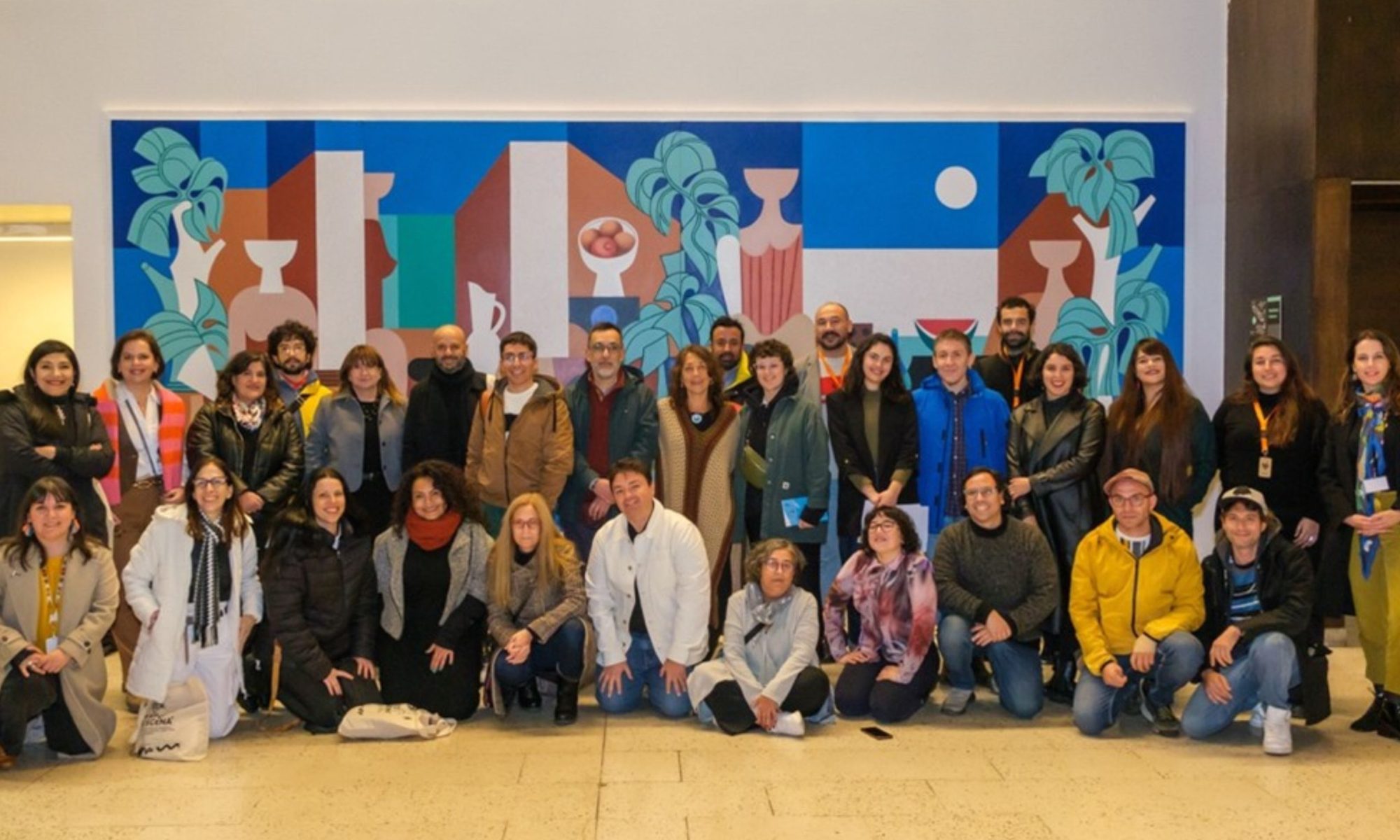 A group shot of FAMFEST attendees, with a row of people standing, and another row kneeling in front of them