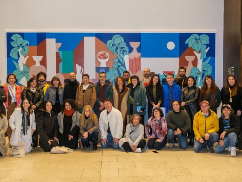 A group shot of FAMFEST attendees, with a row of people standing, and another row kneeling in front of them