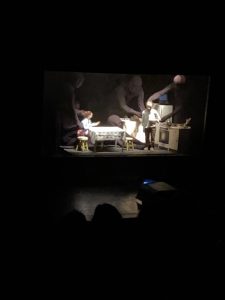 Characters on stage during a performance of On The Tightrope (Chile)
