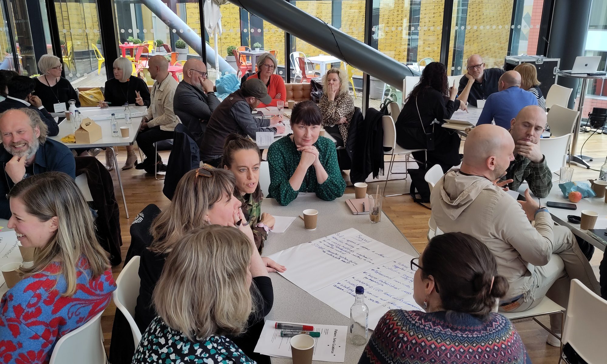 Groups of people talking around tables