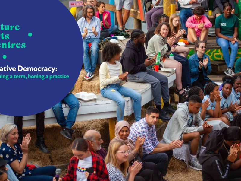 Photo of a group of people, overlaid with Future Arts Centres logo and report title 'Creative Democracy: Defining a term, honing a practice'.